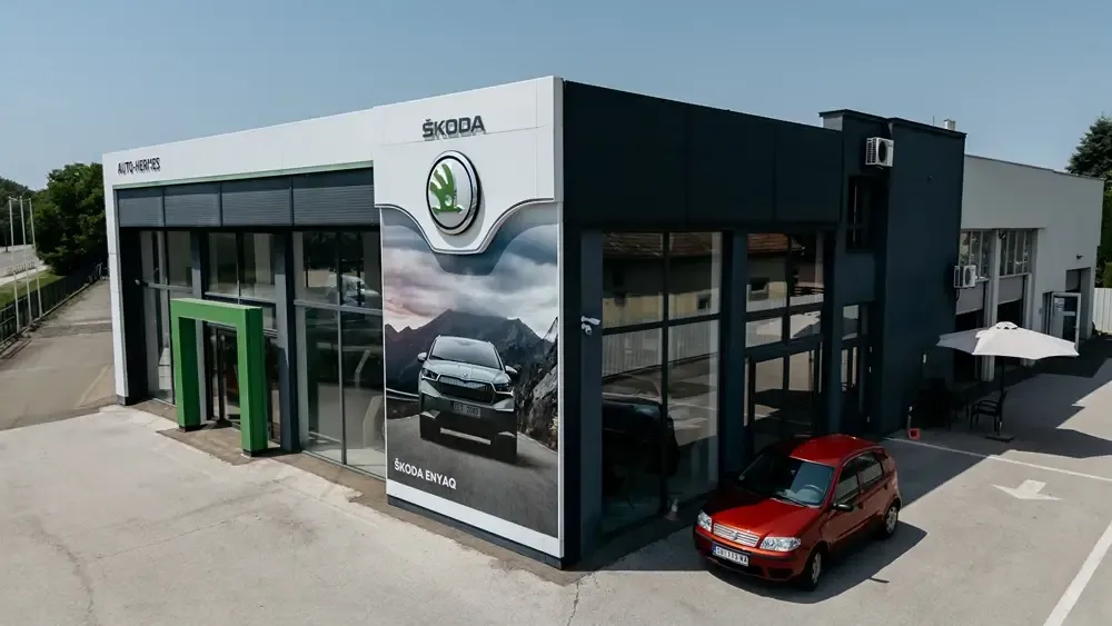Izložbeni salon Škoda sa velikim izlozima i zelenim ulaznim portalom